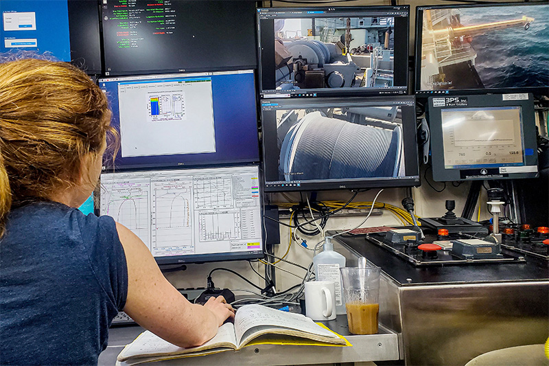 Research Scientist Julia Brown examines data while aboard a cruise