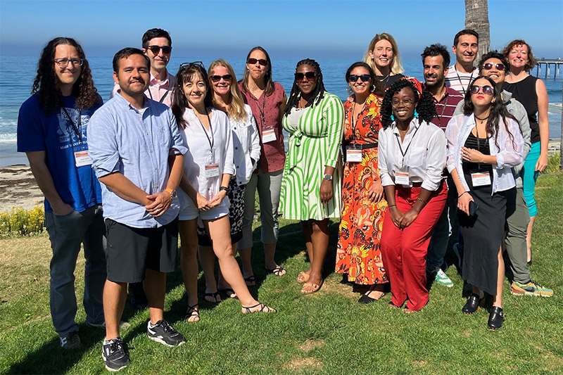 Participants of a COBRA mini-workshop posing for a grouop picture in fron of an ocean backdrop