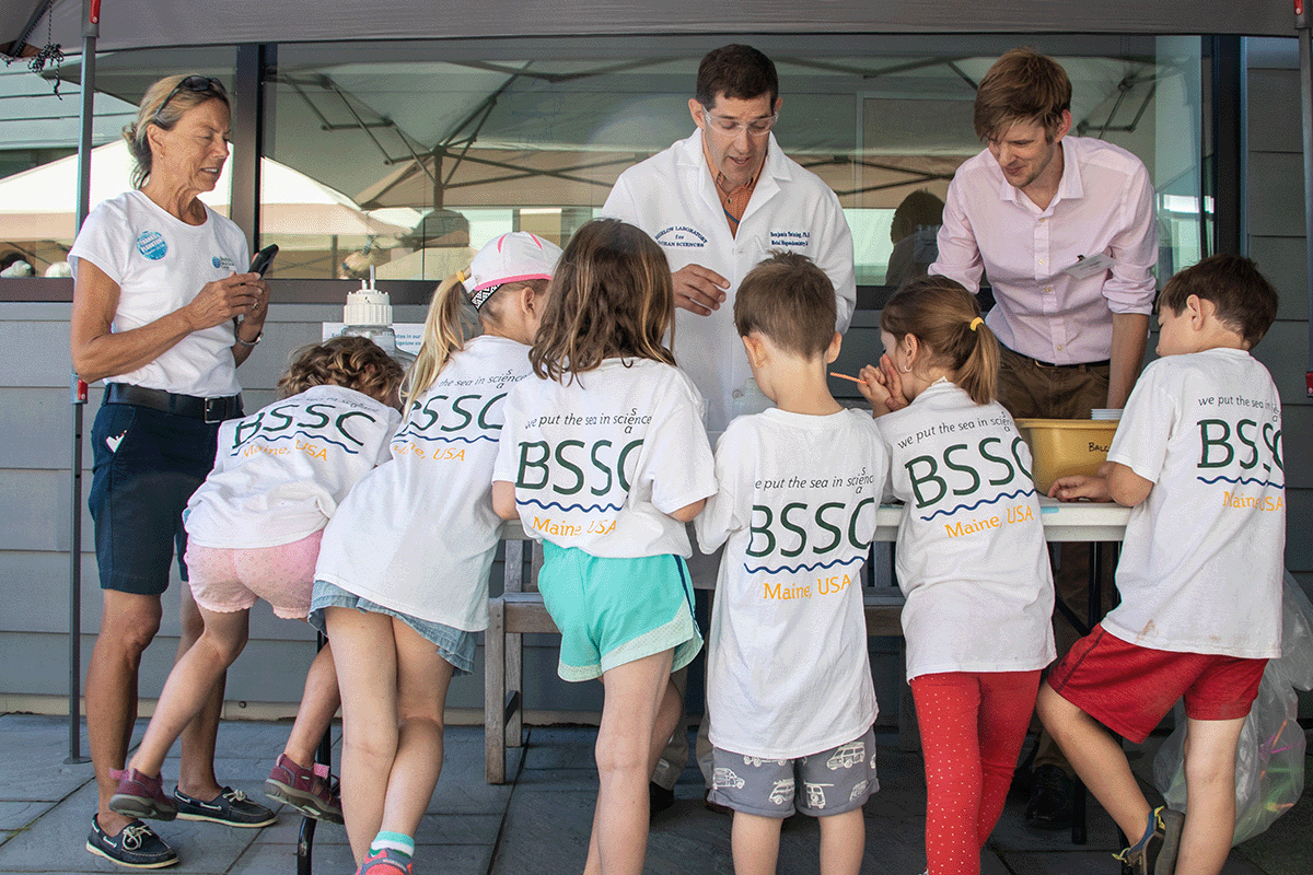 schoolchildren atytending a science demonstration klled by Sr. Research Scientists Ben Twining & Christoph Aeppli